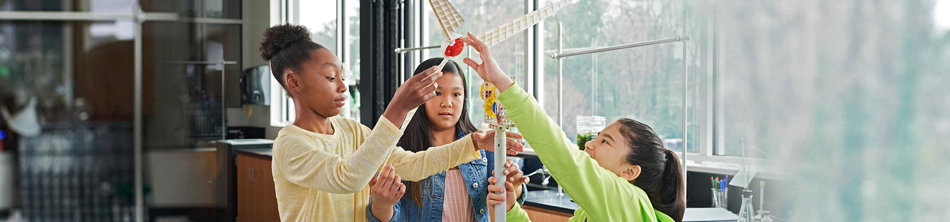  girls working on a science project 