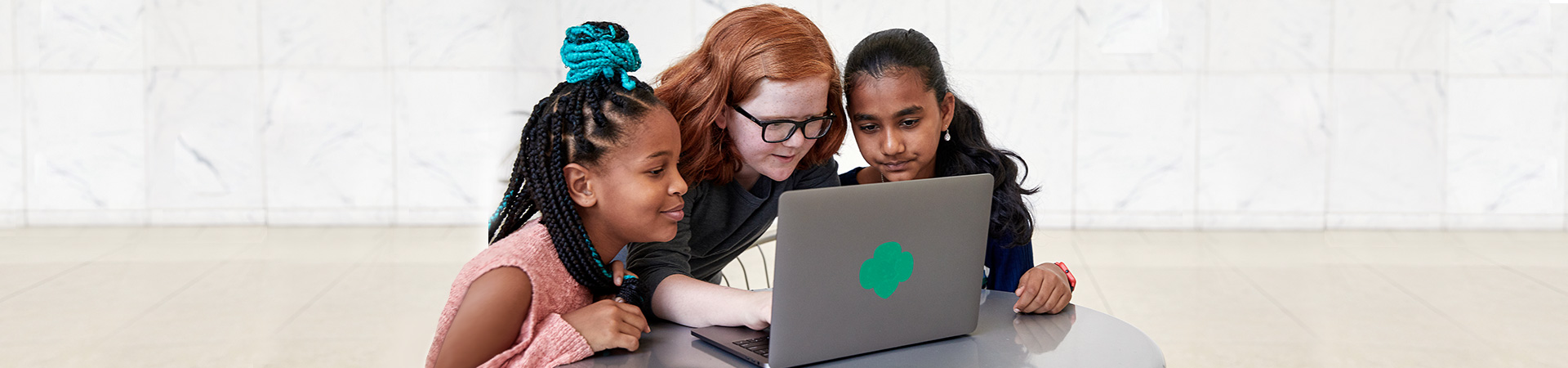  Girls looking at a computer together 