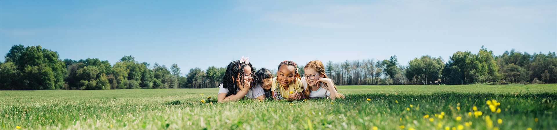  young girl scouts in daisy uniforms smiling together 