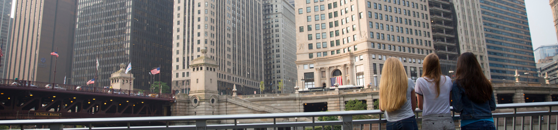  Girls looking at a city scape of tall buildings and architecture 