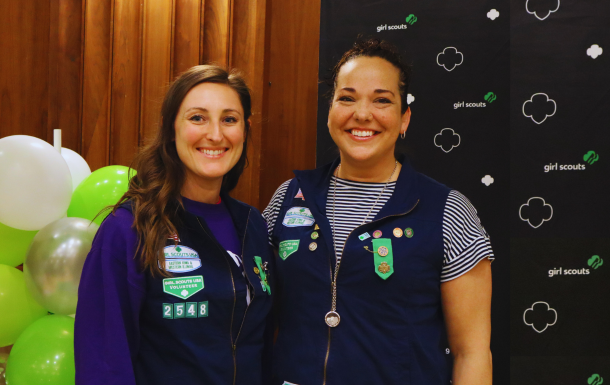 Two adult volunteers smiling together